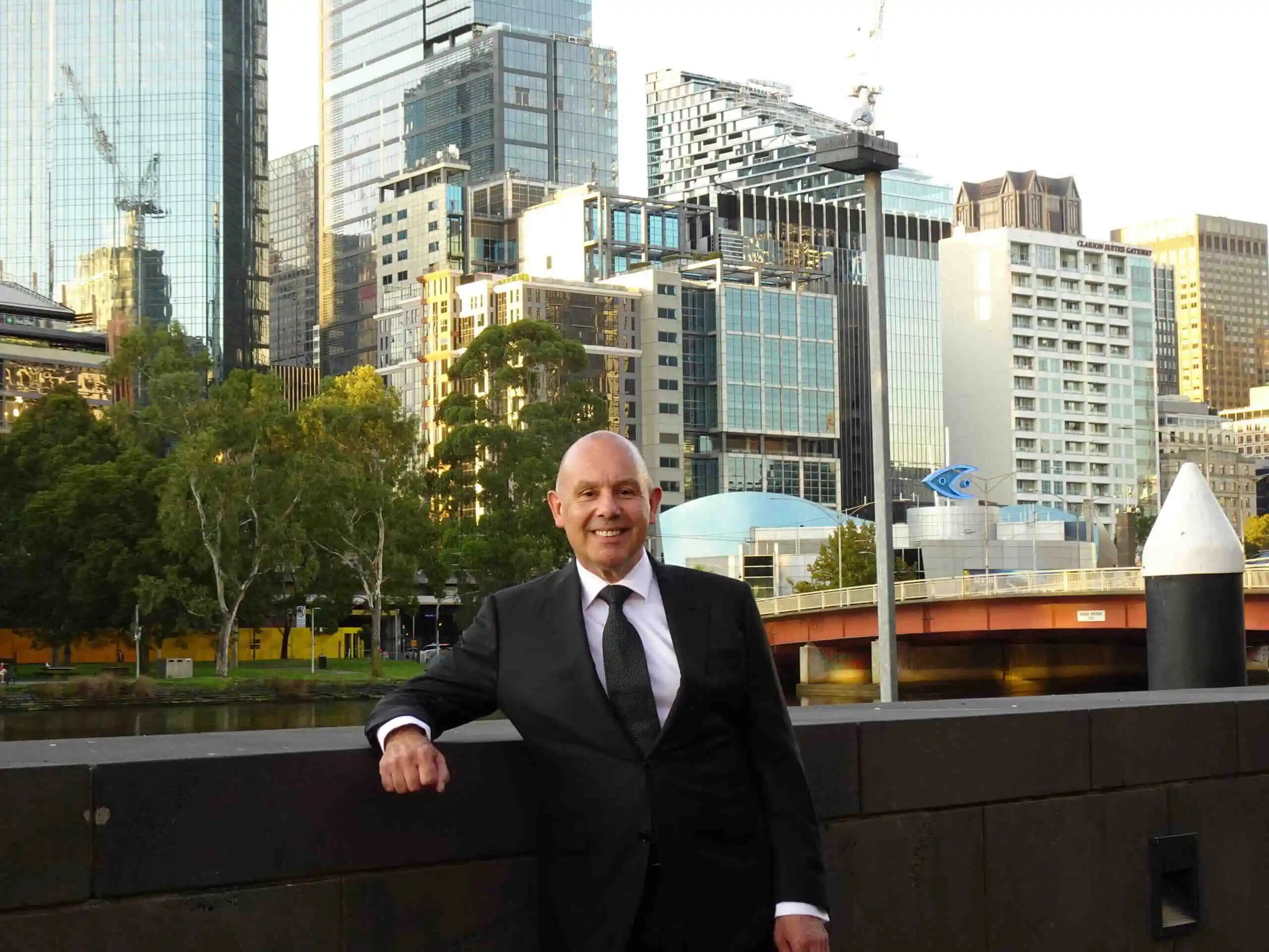 Bernard Whimp standing in front of buildings in Melbourne.